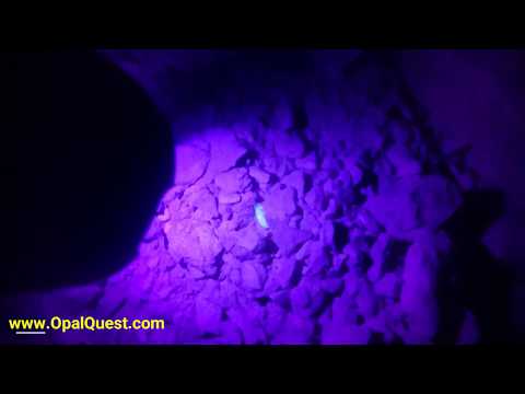 Opal in floor of mine using black light